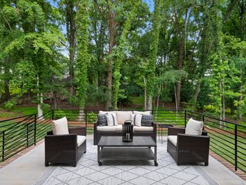 Large raised patio with black metal rails