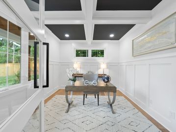 New office with coffered ceiling two toned paint, chair moldings and French glass doors.