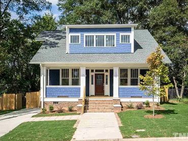 Blue craftsman-style house with white trim and front porch.