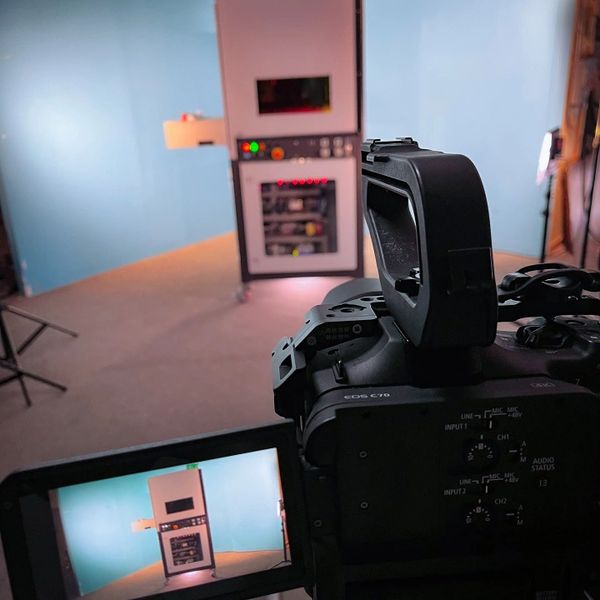 Camera filming an industrial control panel in a studio.