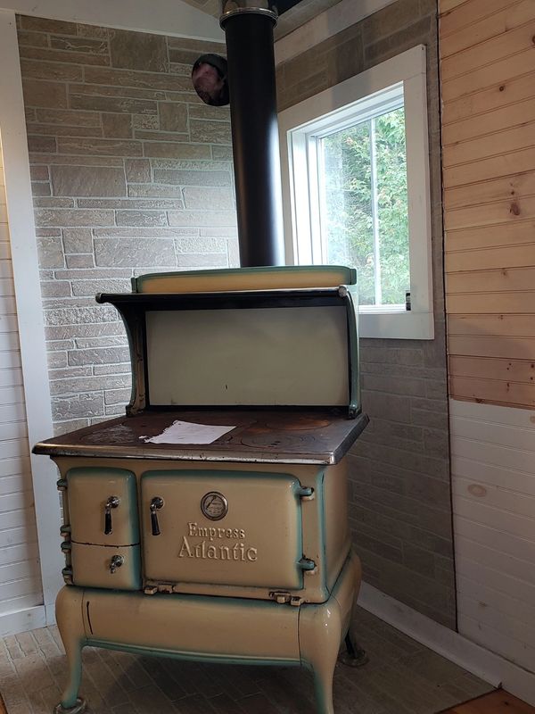 A non-compliant stove on Long Island Maine. The board behind and under the stove isn't fire rated. 