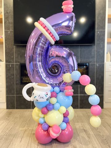 A tea party themed number stack with a party wand for the birthday girl. 