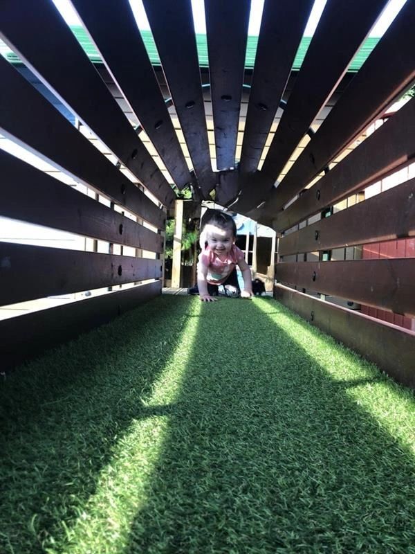 Child crawling under tunnel