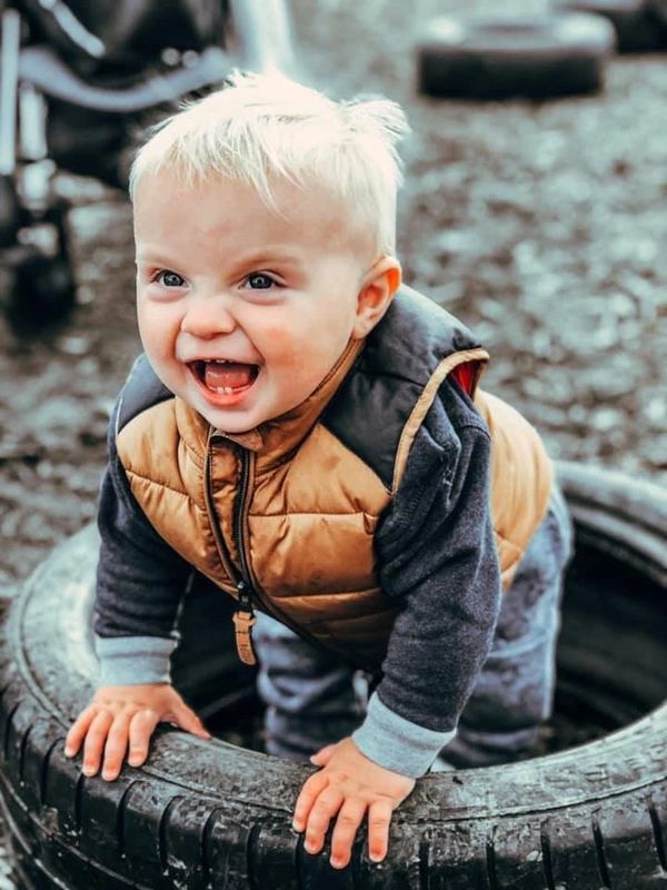 Child playing with tyres
