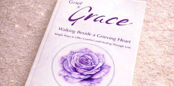 Book titled 'Grief to Grace' with a purple rose on the cover.