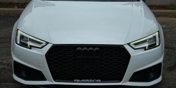 Fully detailed Audi car. Front view with illuminated headlights and sun roof. 