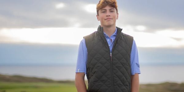 The owner of the company, Braxton LaClair, is standing on a golf course. 