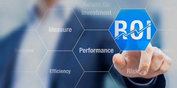 Businessman pointing at ROI on a virtual screen with related terms.