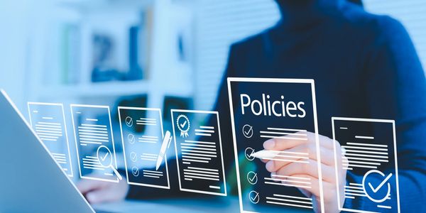 Person interacting with virtual policy documents on a digital interface.