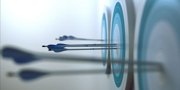 Blue arrows perfectly hitting the center of multiple archery targets.