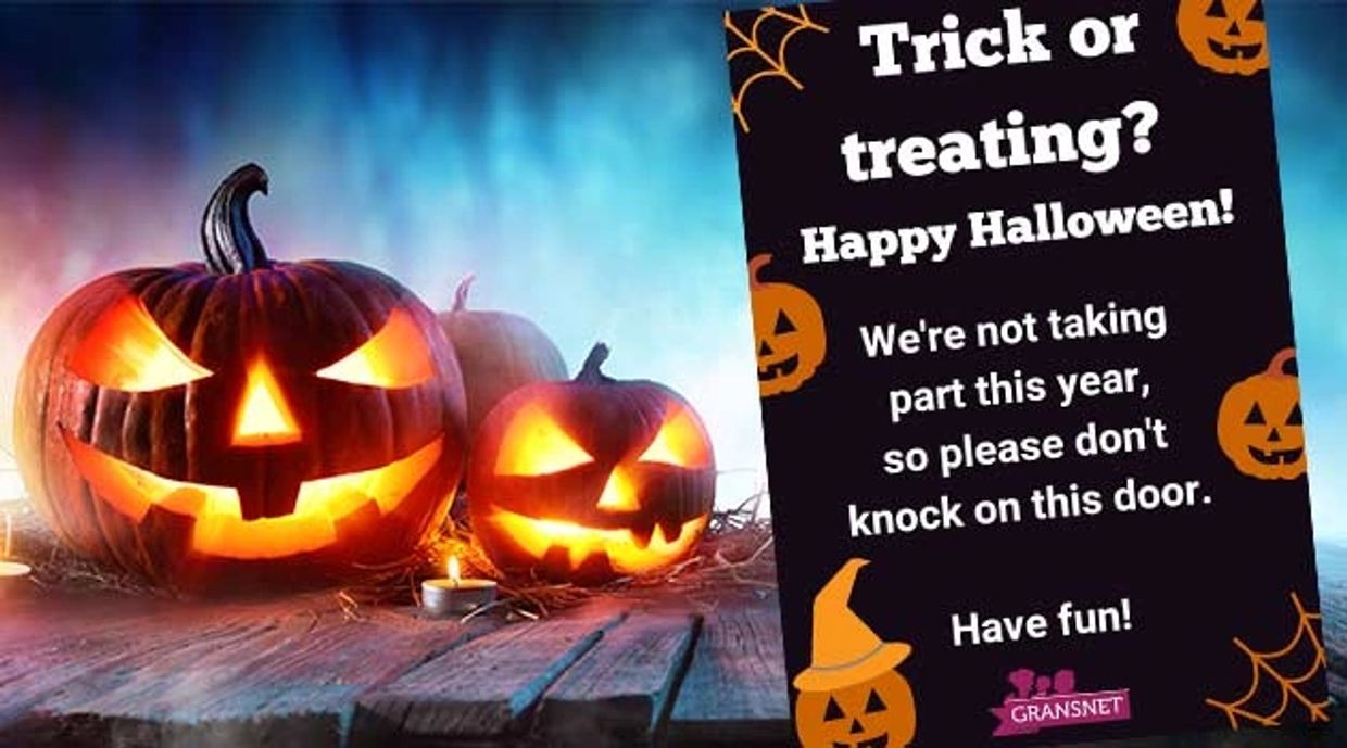 Halloween pumpkins with a sign saying no trick-or-treating this year.