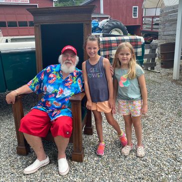 Girls visiting with Santa at "Christmas in July" at Silver Bell Farm.