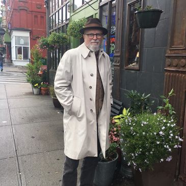 cool guy on Brooklyn street wearing vintage hat and raincoat
