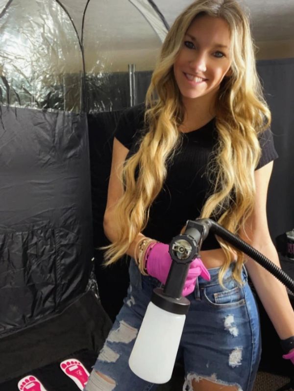 A girl holding a spray bottle