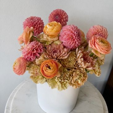 Colorful flower bouquet in a white vase.