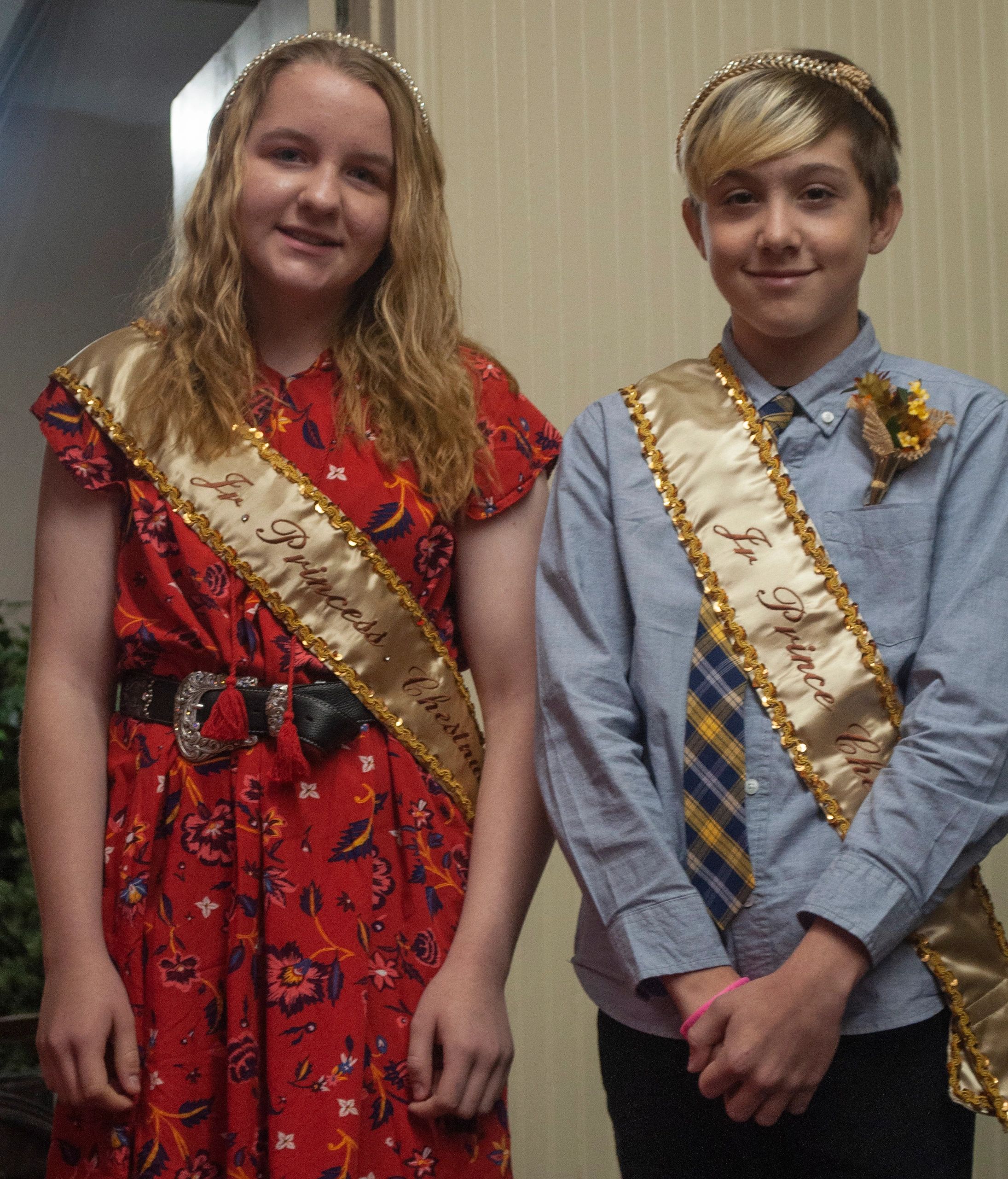 Two young individuals wearing sashes reading Jr. Prince and Jr. Princess.