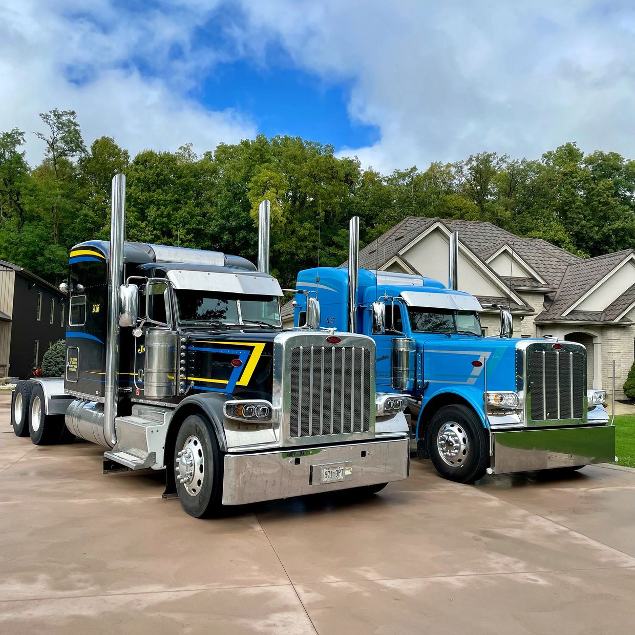Two stunning Peterbilt 389 trucks parked side by side in a driveway,
