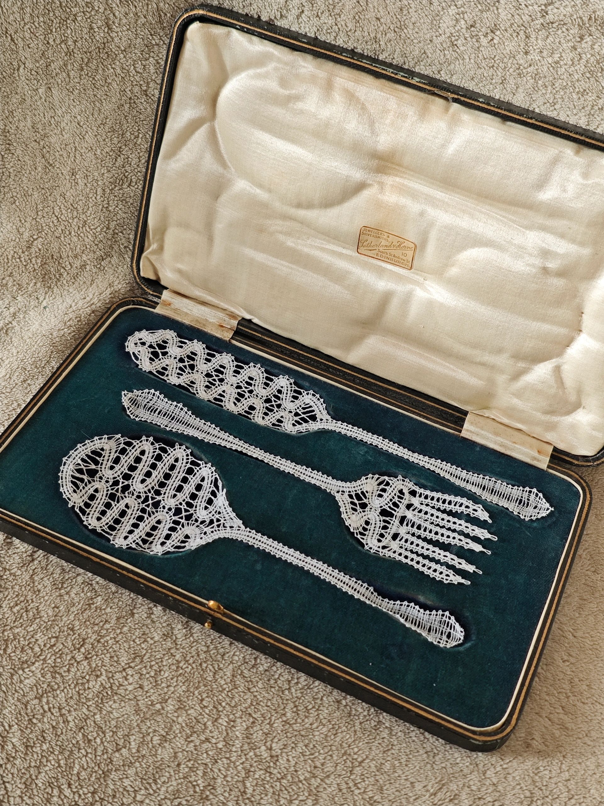 Intricately crafted lace cutlery in a vintage lined case.