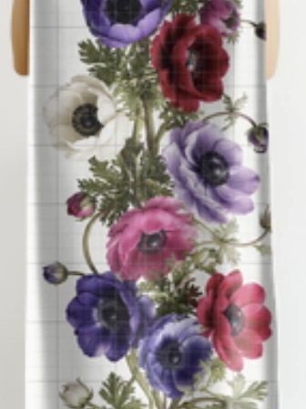 Shower curtain with colorful flower design.