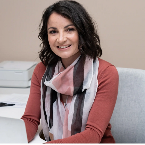 Elizabeth sitting in the counselling room smiling. 