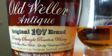 Close-up of Old Weller Antique bourbon bottle and glass.