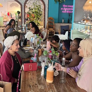 Group enjoying conversation at a cozy cafe table.