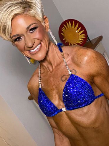 Smiling woman in a sparkling blue bikini.