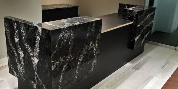 Reception desk and commercial cabinets. Custom mitered waterfall connected all the way around. 