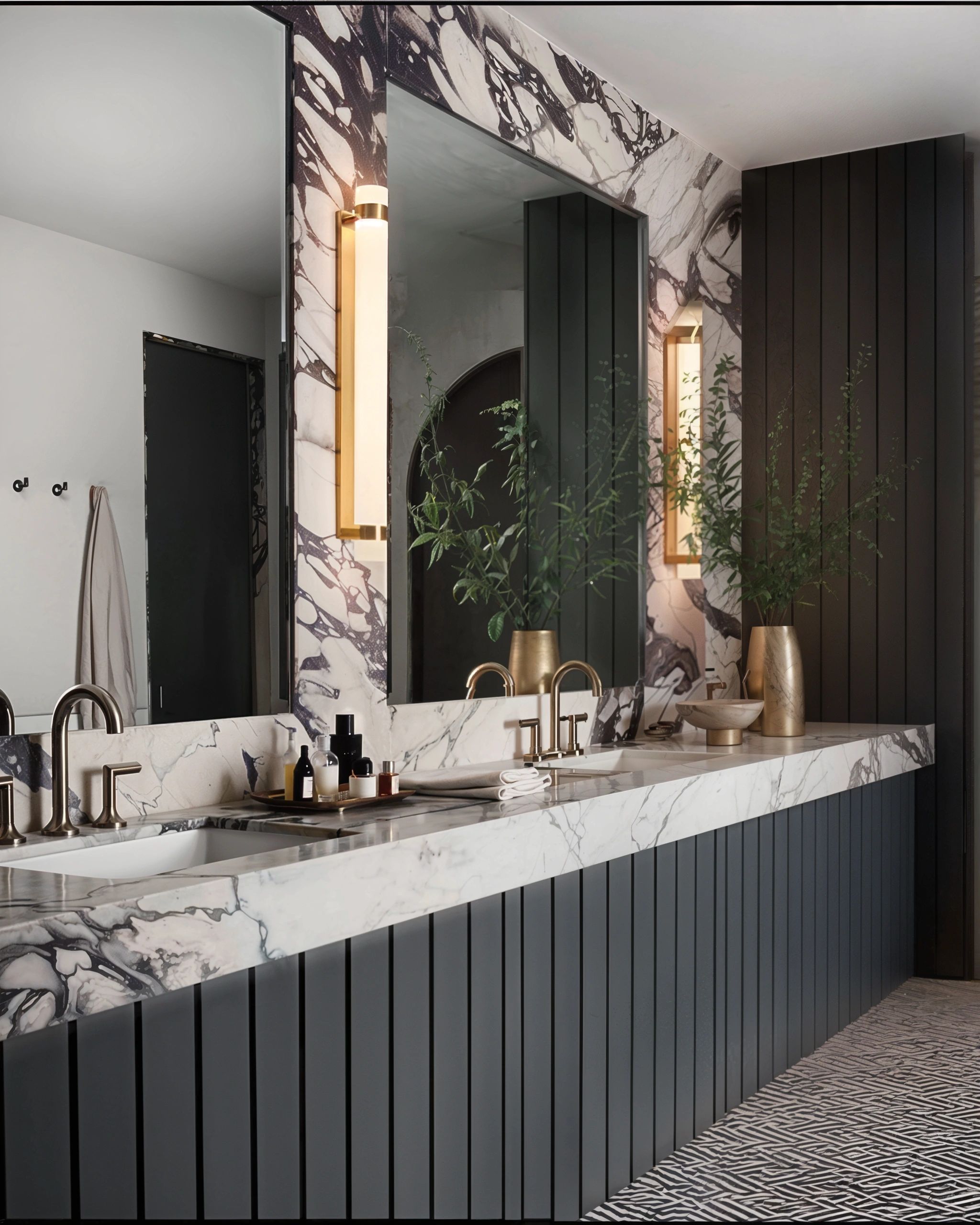 Modern bathroom with marble countertop and gold fixtures.