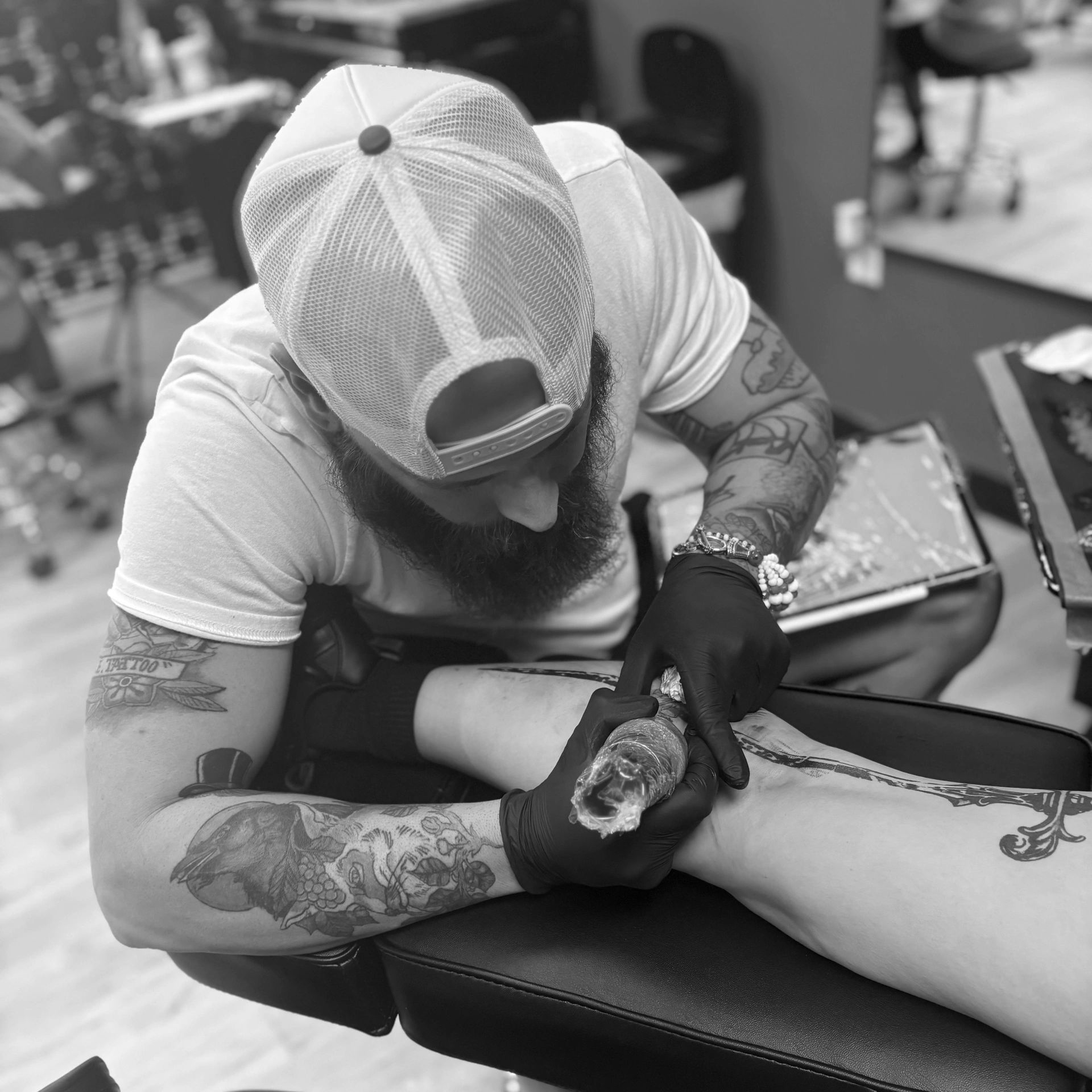 A tattoo artist working on a tattoo.
