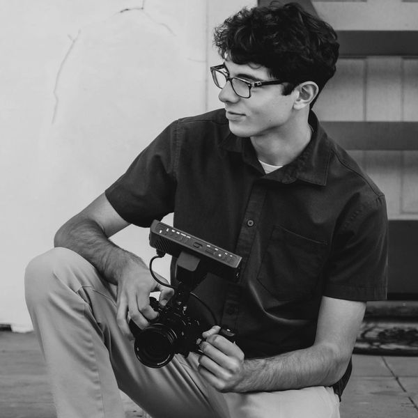 Bryce Faber holding his original camera, a Sony ZVE-10.