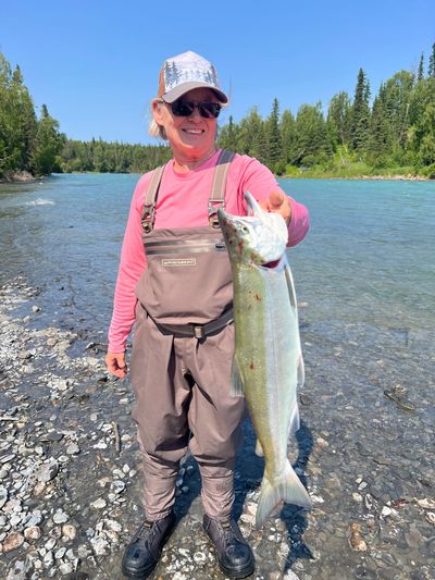 A happy angler with her first Sockeye Salmon, on her first fishing trip to Alaska. 