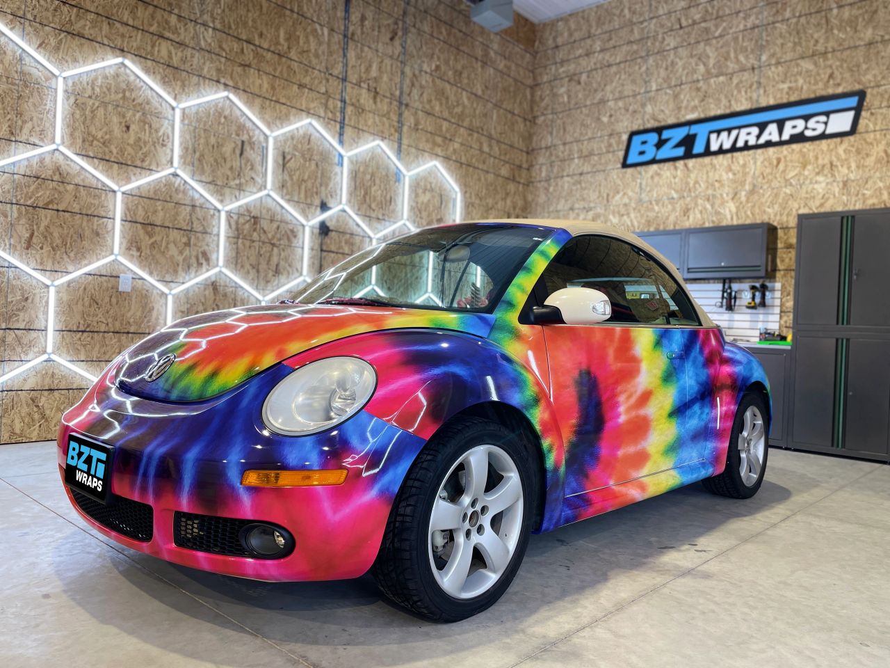 Volkswagen Beetle covered with colorful tie-dye graphics