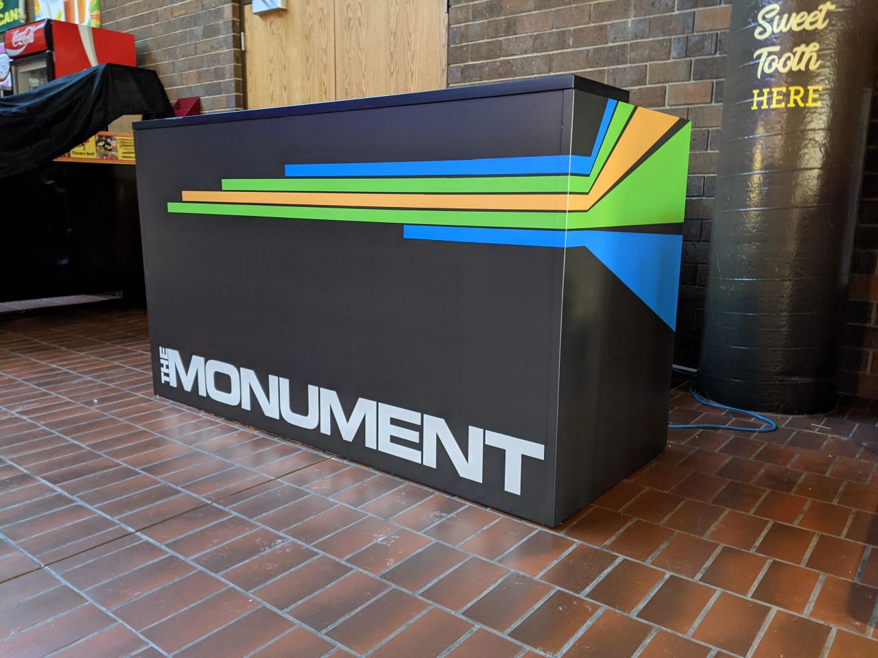The Monument branding displayed across the front of a counter