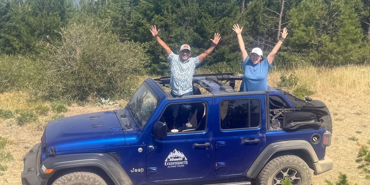 Guests enjoying an open-air scenic mountain ride on a private Leavenworth Alpine Tours Jeep excursion.