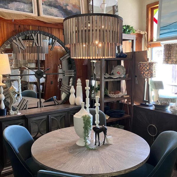 Cozy dining area with round table and blue chairs.