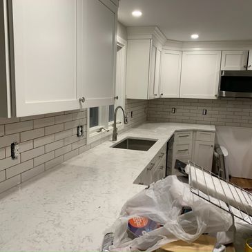 Quartz countertop installation and subway tile backsplash