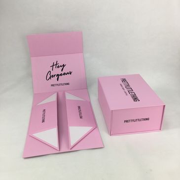 Pink PrettyLittleThing packaging with stylish text and compartments.