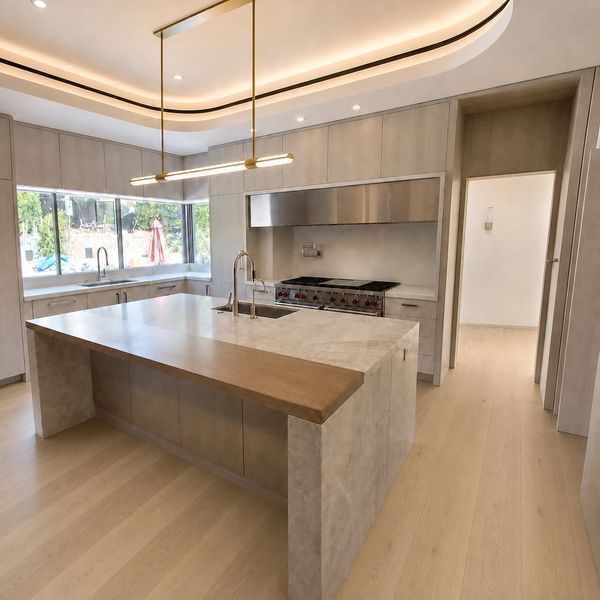 A sleek, modern kitchen designed with custom kitchen cabinets and integrated accent lighting. 