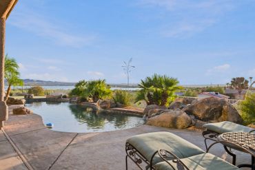 Scenic pool with palm trees and amazing lake views.