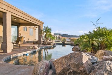 A serene backyard with pool and desert landscaping.