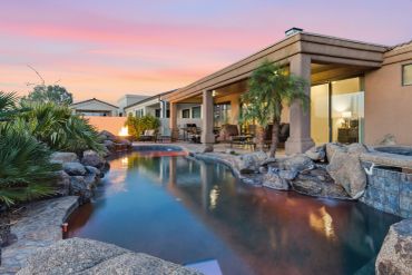 Luxurious backyard with a pool at sunset.