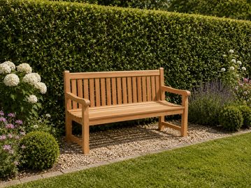 Wooden garden bench on gravel with lush green hedge and flowers.