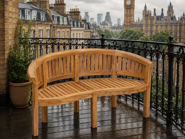 Wooden bench on a balcony overlooking London skyline and Big Ben.