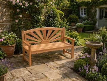 Wooden garden bench with sunburst design in a lush garden.
