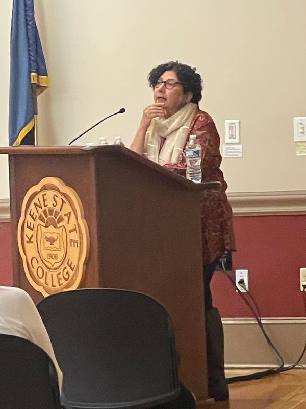 Speaker presenting at Keene State College podium.