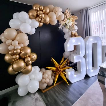Elegant gold and white balloon arch with led light numbers.