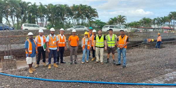 CMS Fiji project management team reviewing construction plans