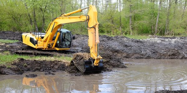 Excavator digging  a pond