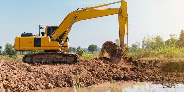 Excavator digging a pond